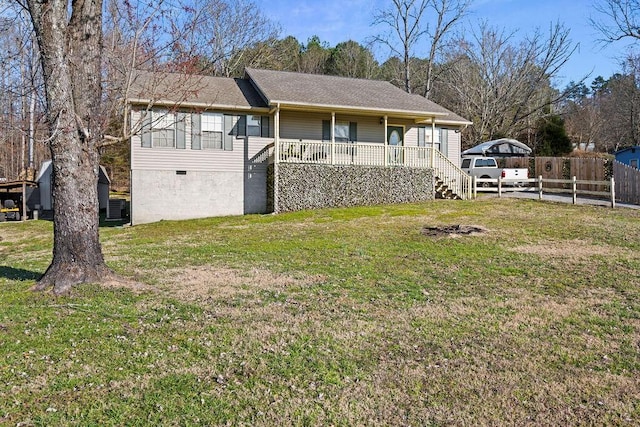 exterior space with a lawn, a porch, and fence