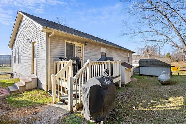 exterior space with a deck, entry steps, a storage shed, and an outdoor structure