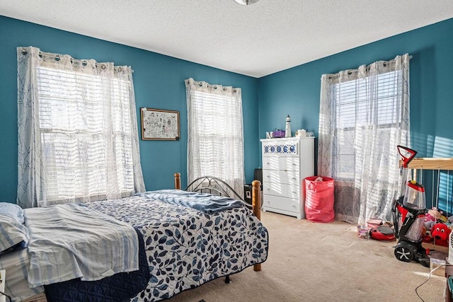 bedroom featuring a textured ceiling and carpet floors