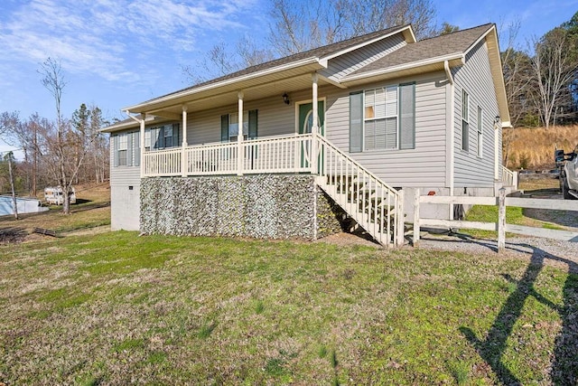 ranch-style home with covered porch and a front yard