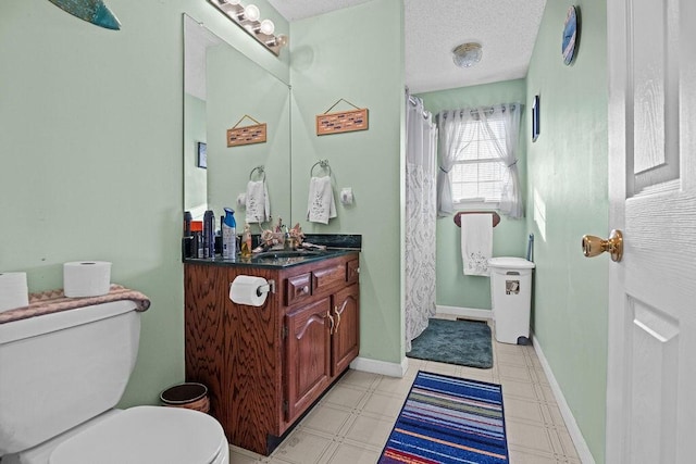 full bath featuring baseboards, toilet, vanity, tile patterned floors, and a textured ceiling