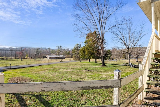 view of yard with stairway and fence