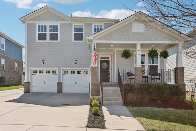 craftsman-style house with concrete driveway, a garage, and covered porch