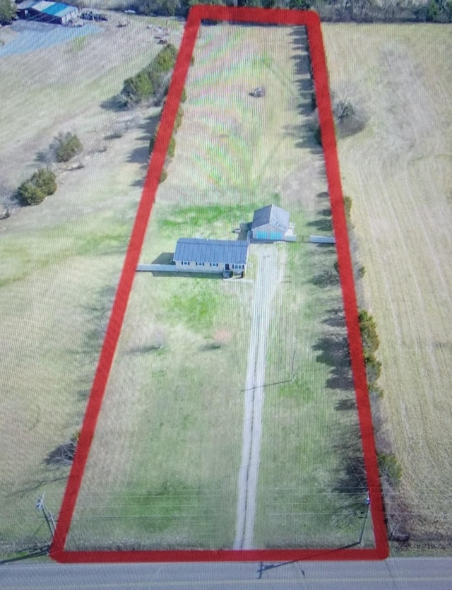 birds eye view of property with a rural view