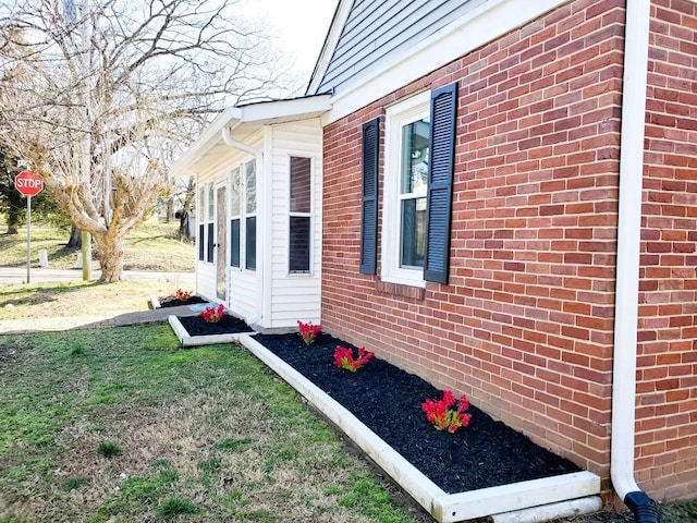 view of side of home with brick siding