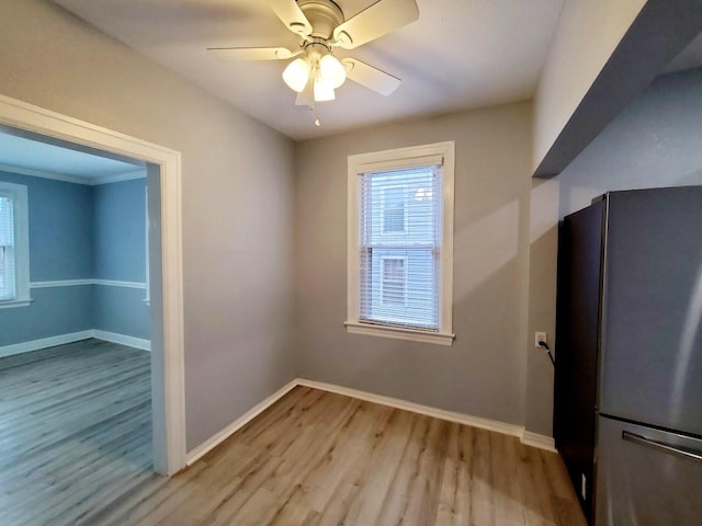 interior space with ceiling fan, baseboards, and wood finished floors