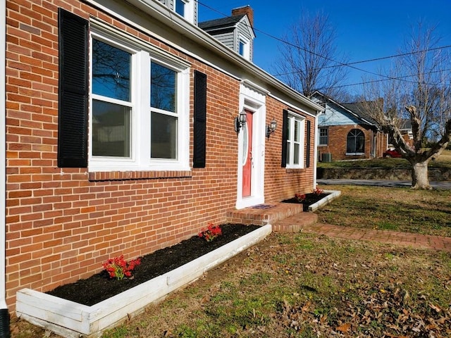 view of side of home with brick siding