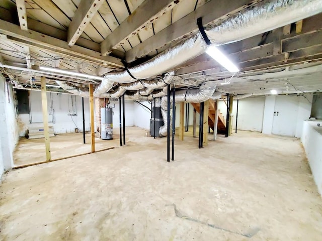 unfinished basement with gas water heater and heating unit