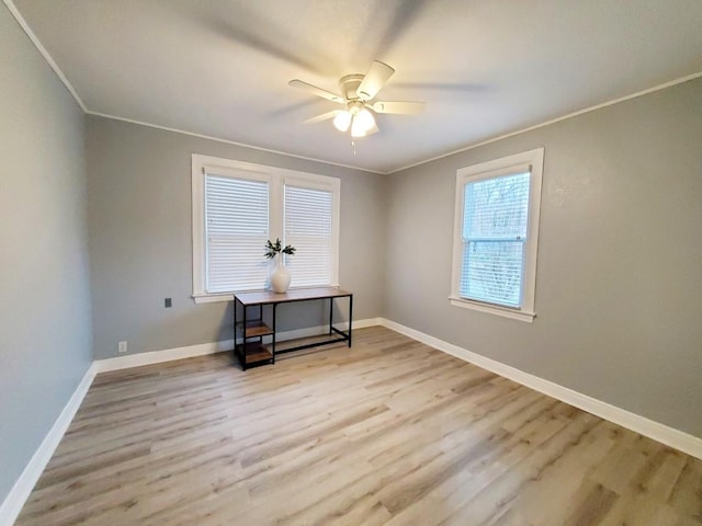 interior space with baseboards, wood finished floors, and crown molding