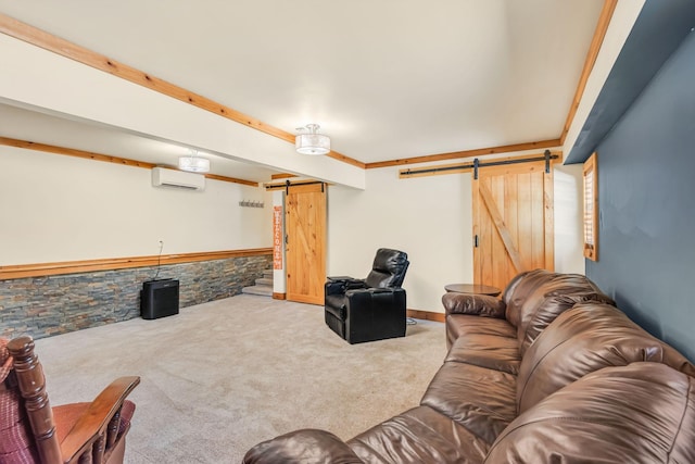 carpeted living room featuring a wainscoted wall, an AC wall unit, and a barn door