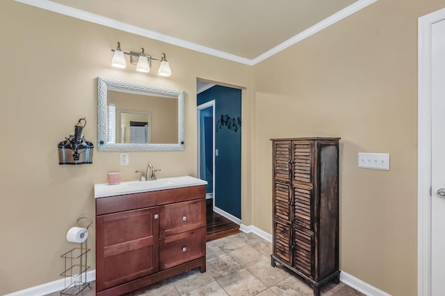 bathroom featuring vanity, crown molding, and baseboards