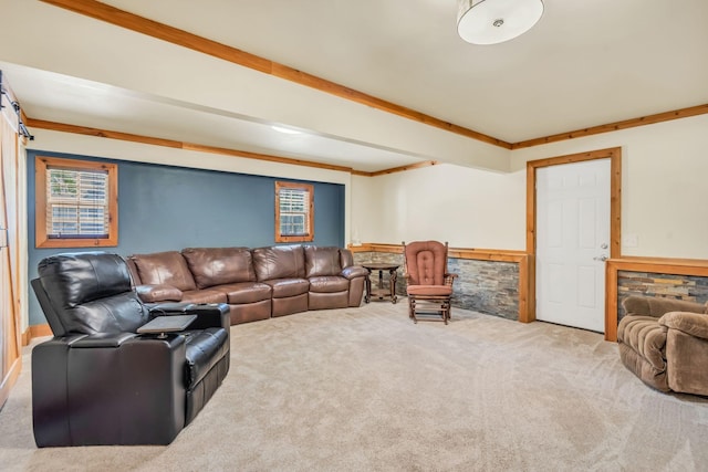 carpeted living area featuring a wainscoted wall and beamed ceiling