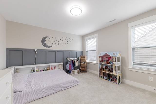 carpeted bedroom featuring baseboards and visible vents