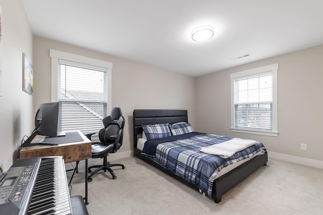 carpeted bedroom featuring visible vents and baseboards