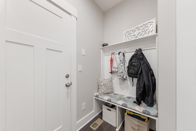 mudroom with baseboards and dark wood-style flooring