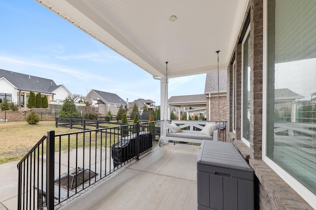 view of patio / terrace with a balcony and a residential view