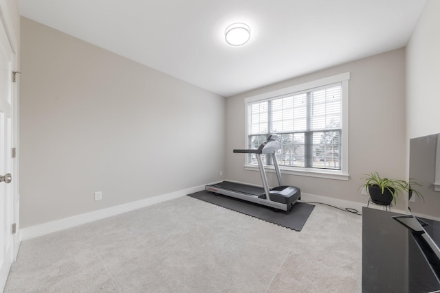 exercise room featuring baseboards and carpet floors