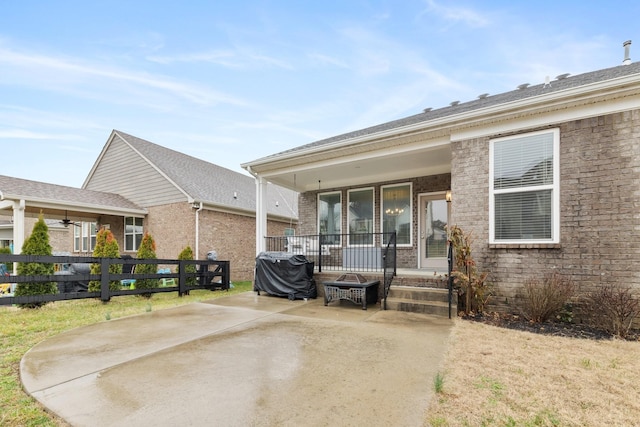 exterior space featuring fence and brick siding