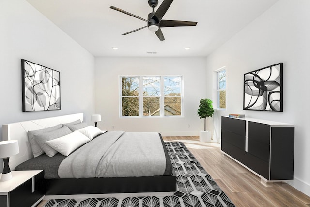 bedroom featuring light wood-type flooring, visible vents, recessed lighting, baseboards, and ceiling fan