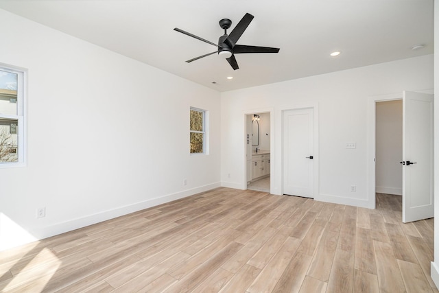 unfurnished bedroom featuring recessed lighting, connected bathroom, baseboards, and light wood-style flooring