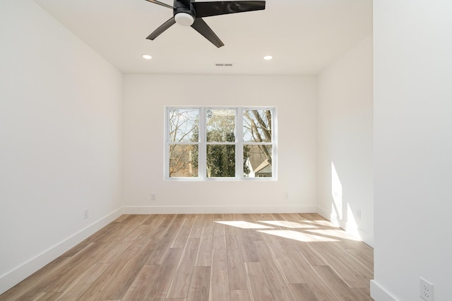 unfurnished room with recessed lighting, visible vents, light wood-style flooring, and baseboards