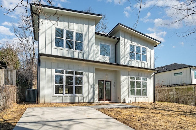 view of front of house featuring central air condition unit, board and batten siding, and fence