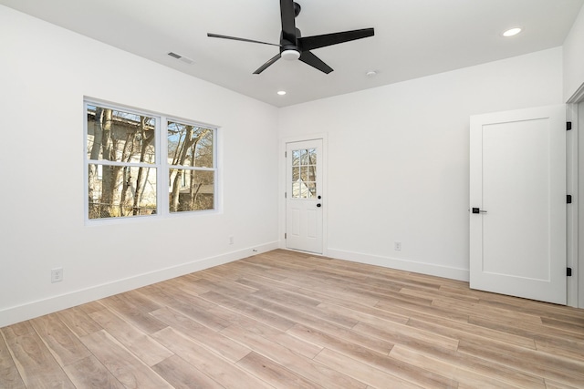 empty room featuring a ceiling fan, baseboards, visible vents, recessed lighting, and light wood-type flooring