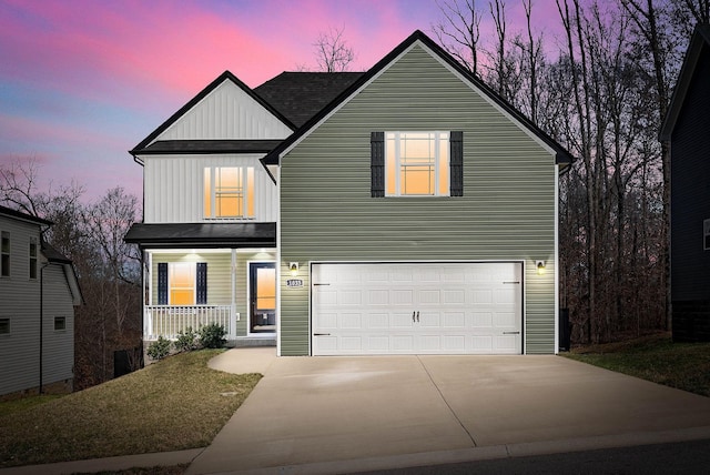 traditional home with covered porch, board and batten siding, concrete driveway, an attached garage, and roof with shingles