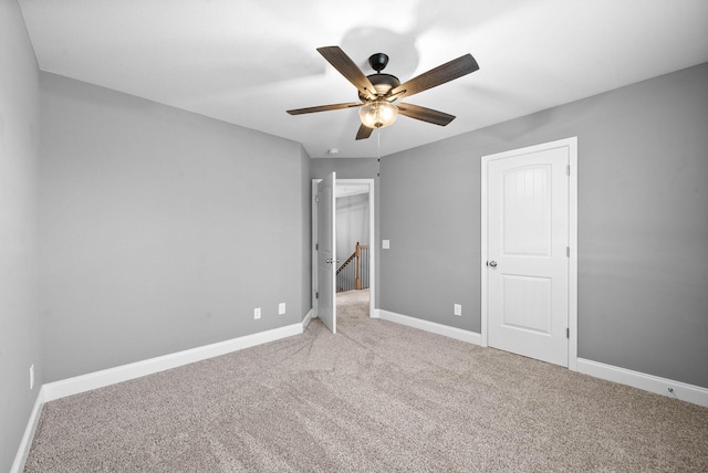 unfurnished bedroom featuring carpet flooring, ceiling fan, and baseboards