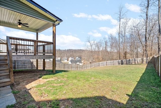 view of yard featuring a fenced backyard and ceiling fan