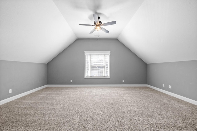 additional living space featuring baseboards, carpet floors, and lofted ceiling