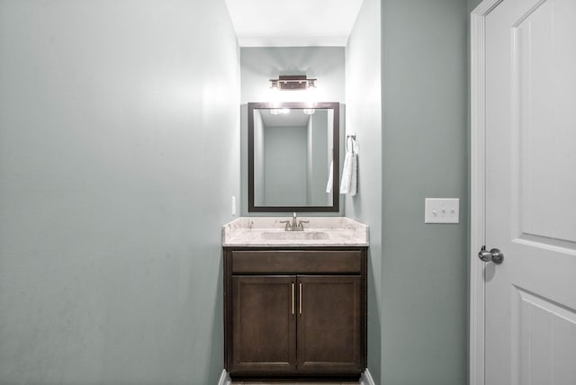 bathroom with vanity and baseboards