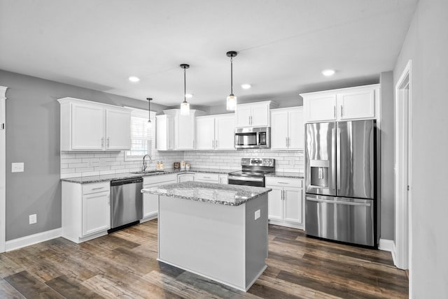 kitchen with white cabinetry, dark wood-style floors, appliances with stainless steel finishes, and a sink