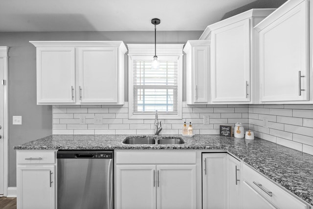 kitchen with tasteful backsplash, dishwasher, stone countertops, white cabinetry, and a sink