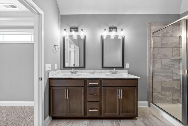 bathroom with a sink, visible vents, double vanity, and a shower stall