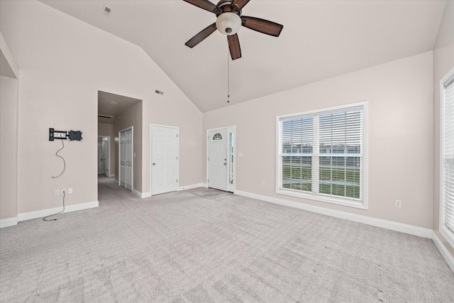 unfurnished living room featuring high vaulted ceiling, light colored carpet, a ceiling fan, and baseboards