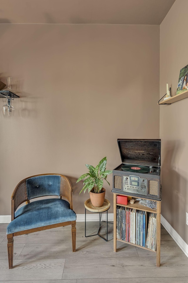 sitting room featuring baseboards and wood finished floors