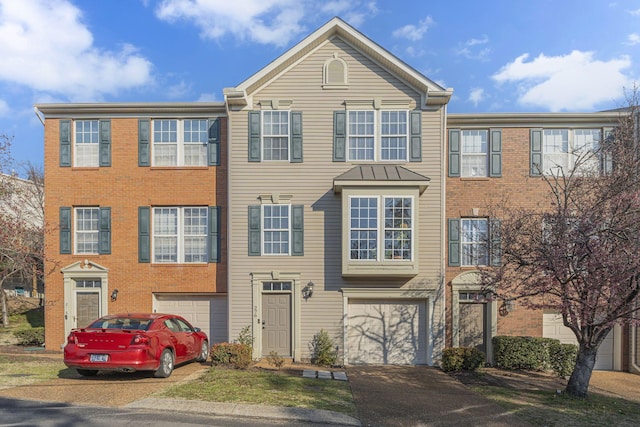 view of property with an attached garage and driveway