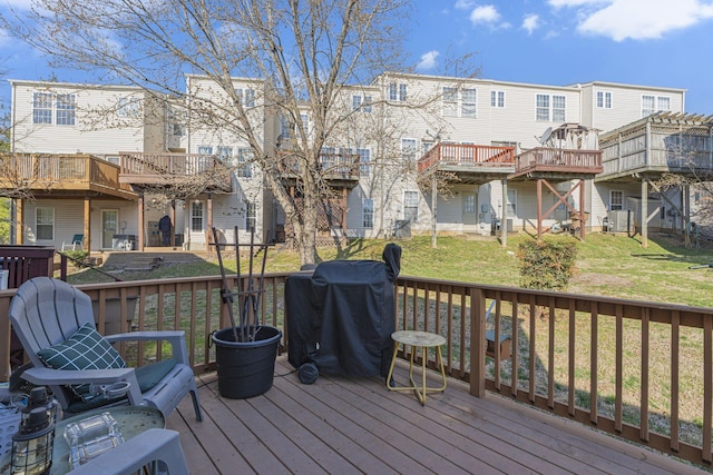 wooden terrace featuring a yard and grilling area