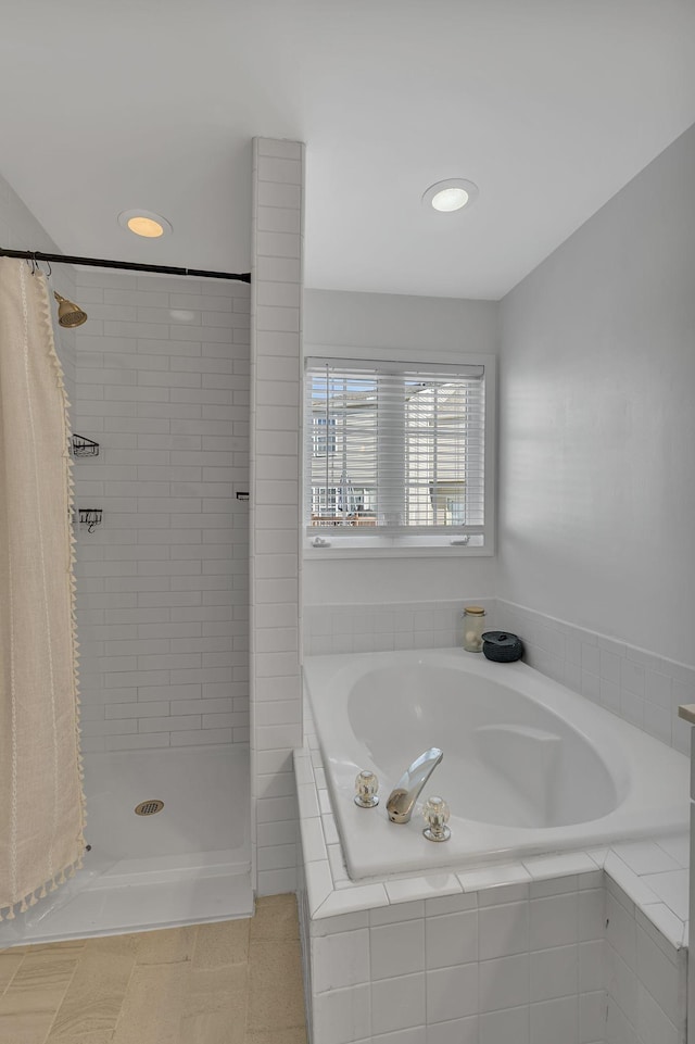 bathroom featuring tiled shower and a garden tub