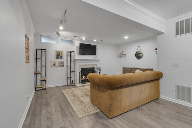 living room featuring visible vents, wood finished floors, and ornamental molding