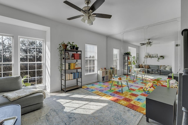 interior space with baseboards and ceiling fan