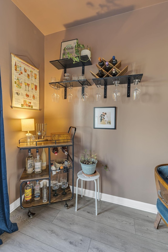 dining space featuring baseboards and wood finished floors