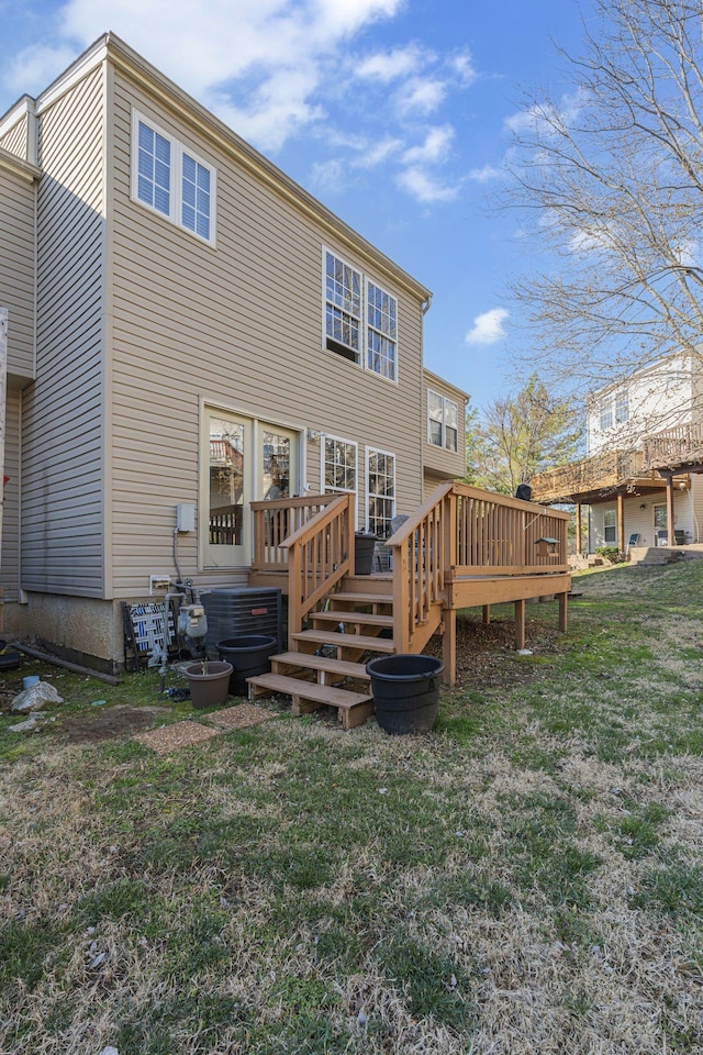 back of property featuring a yard and a deck