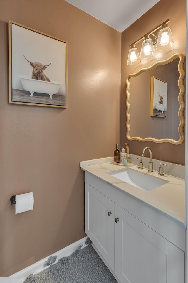 bathroom with baseboards and vanity