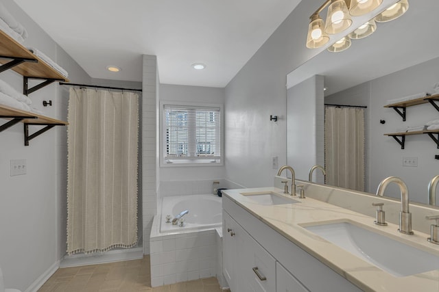 bathroom featuring a sink, curtained shower, and tiled bath