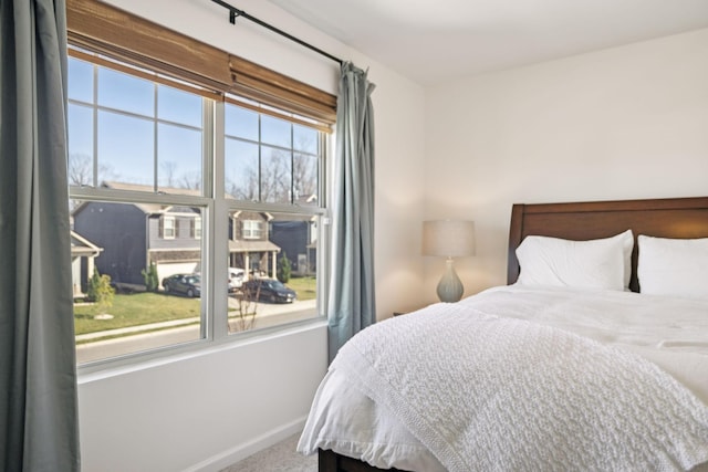 bedroom with baseboards and carpet