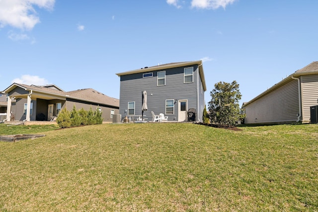 rear view of property with central AC unit and a lawn