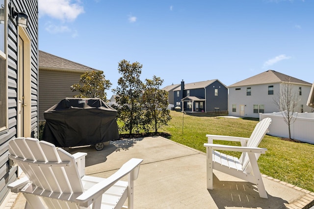 view of patio with a residential view, a grill, and fence