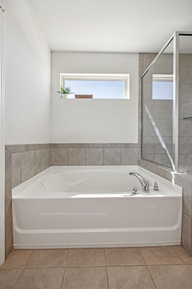 full bathroom featuring tile patterned floors and a bath